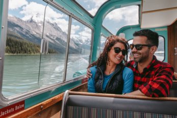 young couple on a boat tour on Maligne Lake