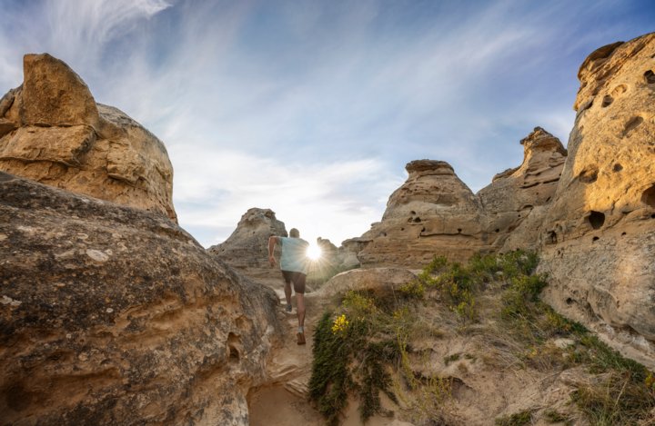 A visitor explores the hoodoos at Writing-On-Stone Provincial Park.