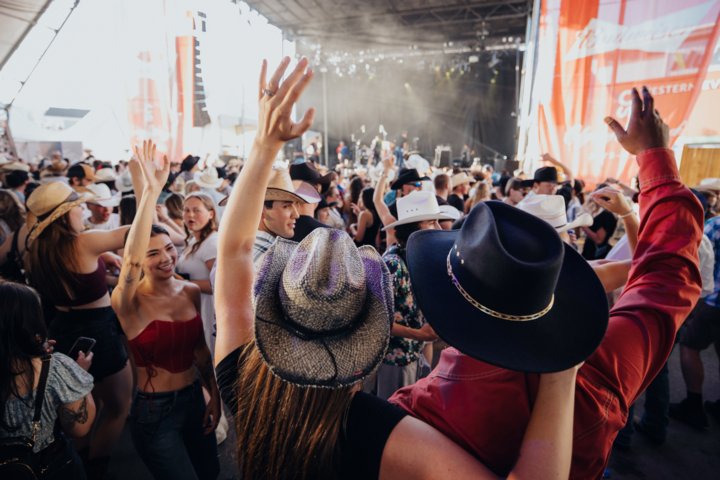 Crowd in cowboy hats enjoying music at Nashville North during the Calgary Stampede