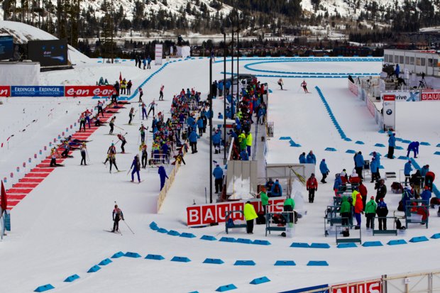 A view from above of a crowd of people preparing for a Biathlon tournament.