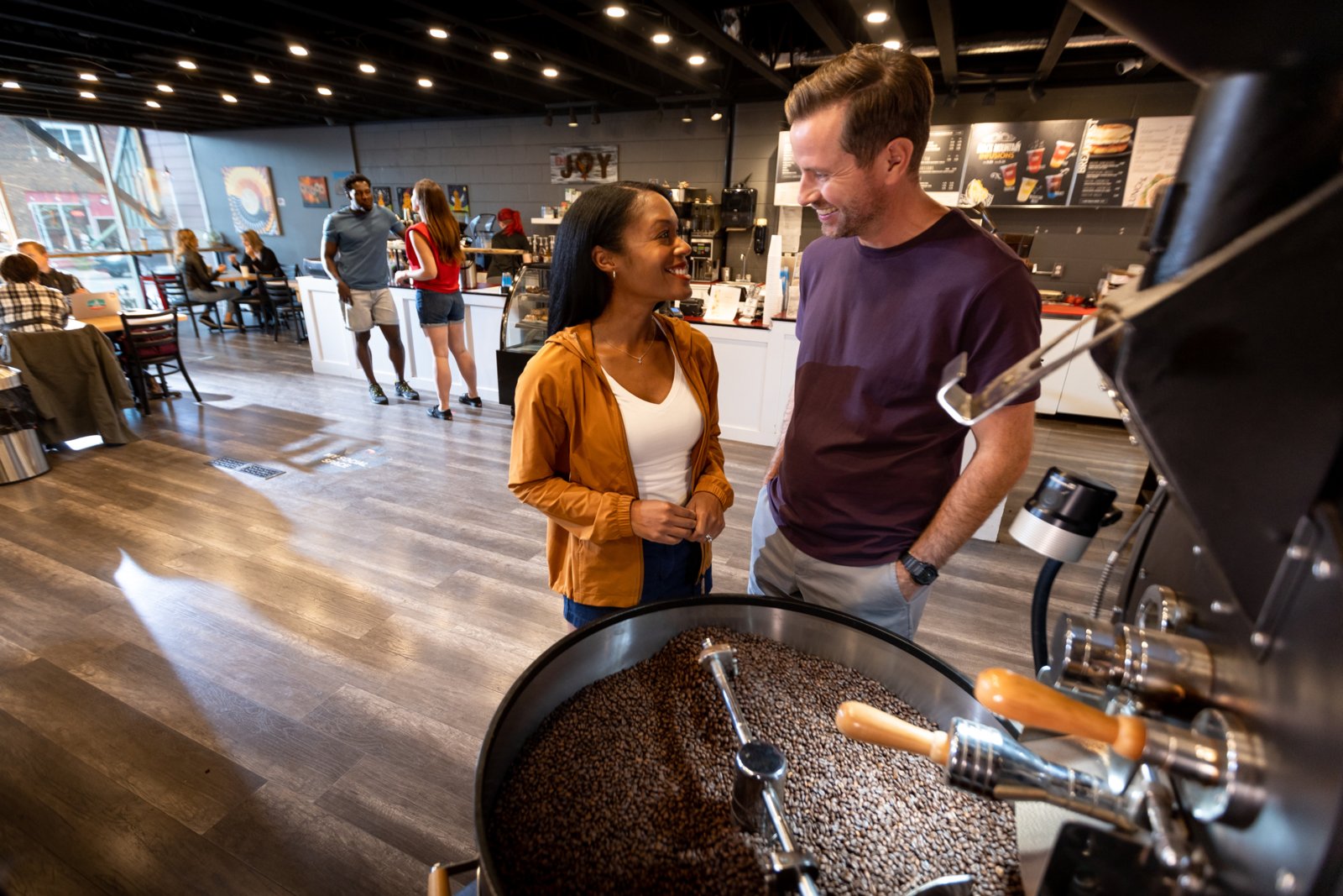 Couple in a coffee shop watching coffee roasting at Black Mountain Roasters in Drumheller.