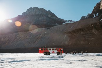 A group exiting the Ice Explorer bus onto a glacier