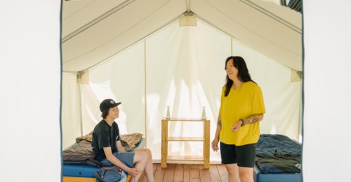 A mother and son inside a tent at Hideaway Adventure Grounds in Smoky Lake.