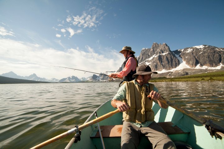 Two men on a fishing boat in the Tonquin Valley in Jasper National Park Alberta