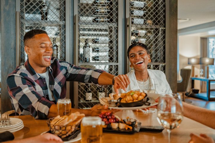 Couple laughing and enjoying a meal at a restaurant