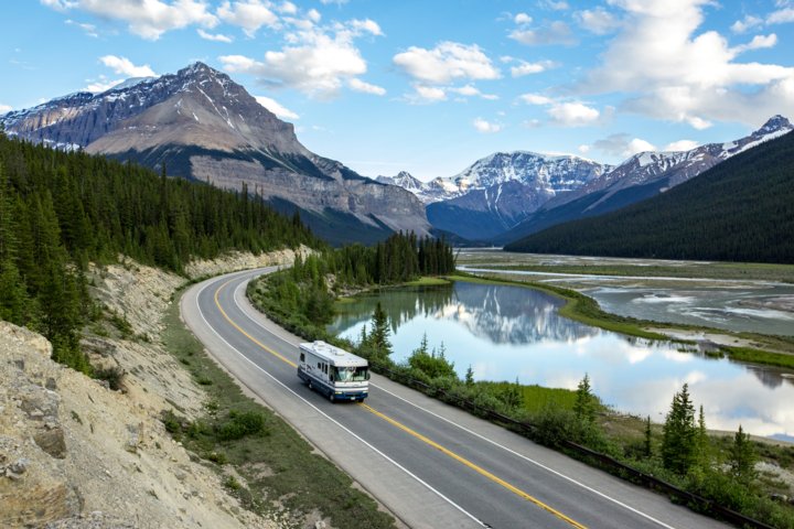View of an RV driving on the Icefields Parkway near Beauty Flats in Jasper National Park.