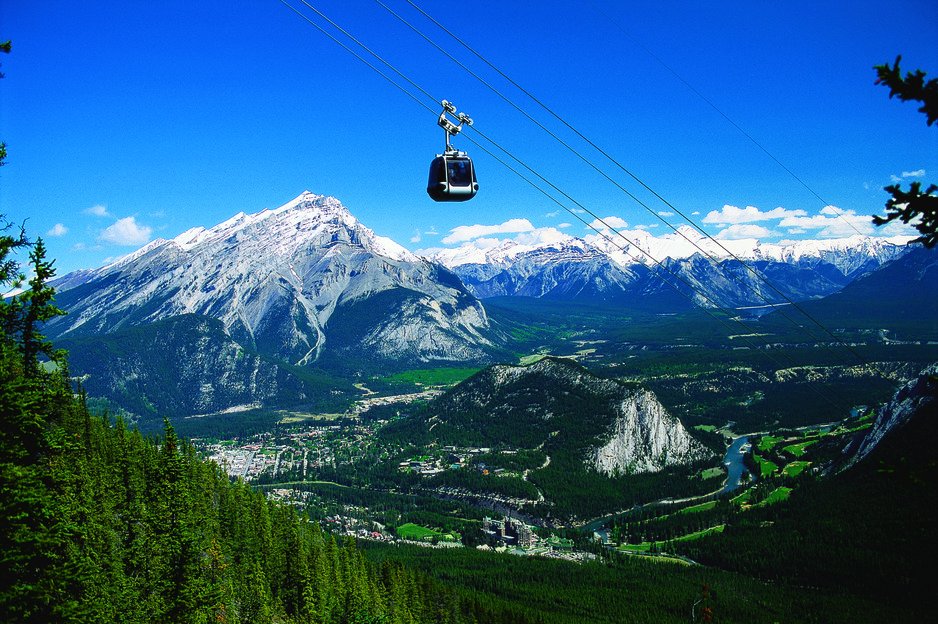A gondola above mountain scenery.