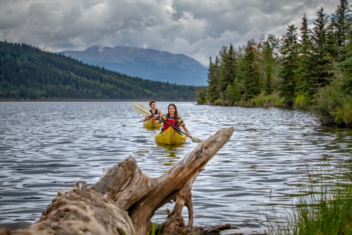 People kayaking on Grande Cache Lake.