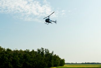 Helicopter hovering over a field
