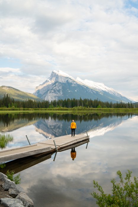 Person standing on a dock at Vermilion Lakes