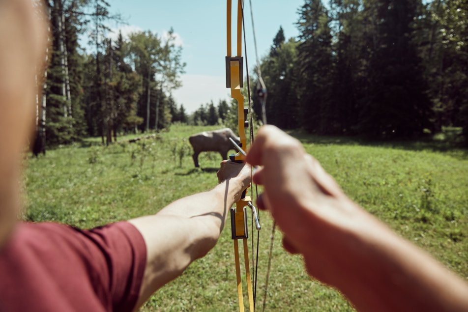 A bow and arrow is pointed at buffalo-shaped target at Painted Warriors Ranch in Alberta.